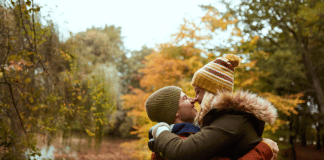 couple kissing in fall setting