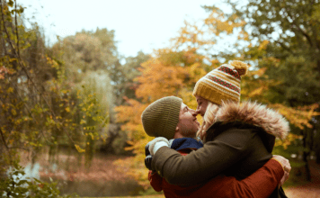couple kissing in fall setting