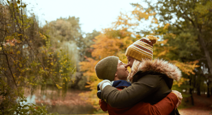 couple kissing in fall setting