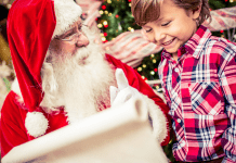 Little boy and Santa looking at list