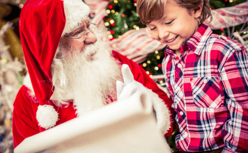 Little boy and Santa looking at list