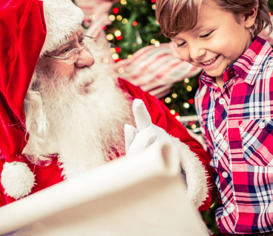 Little boy and Santa looking at list