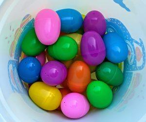 multicolored plastic eggs in a bucket