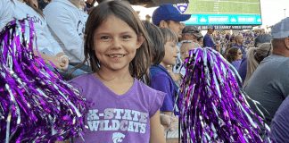 little girl at K-State with pom poms