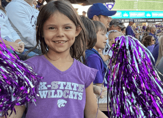 little girl at K-State with pom poms