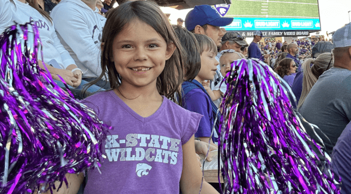 little girl at K-State with pom poms