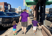 family walking on sidewalk in Aggieville, Manhattan, Kansas