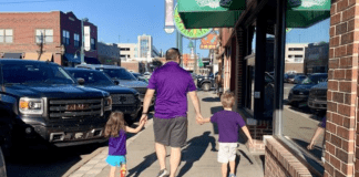 family walking on sidewalk in Aggieville, Manhattan, Kansas