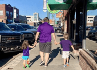 family walking on sidewalk in Aggieville, Manhattan, Kansas