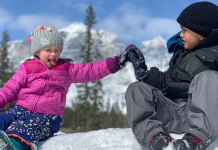 kids high fiving in the snow