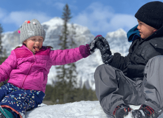 kids high fiving in the snow