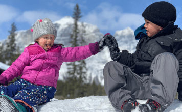 kids high fiving in the snow