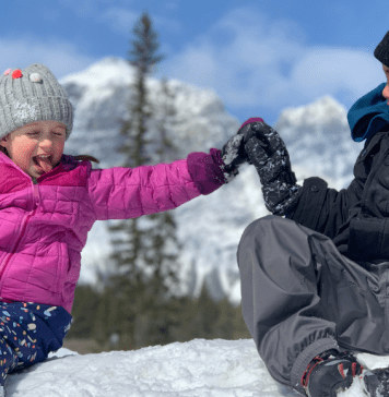 kids high fiving in the snow