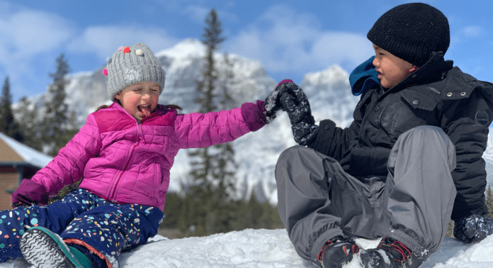 kids high fiving in the snow