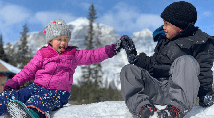 kids high fiving in the snow